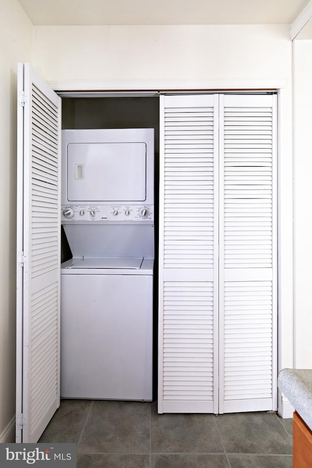 washroom with laundry area and stacked washer / dryer