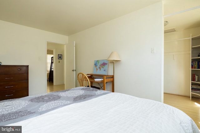 bedroom with a closet and wood finished floors