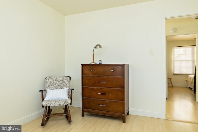 sitting room featuring baseboards and wood finished floors