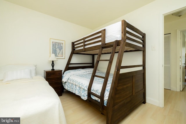 bedroom featuring baseboards and light wood-style flooring