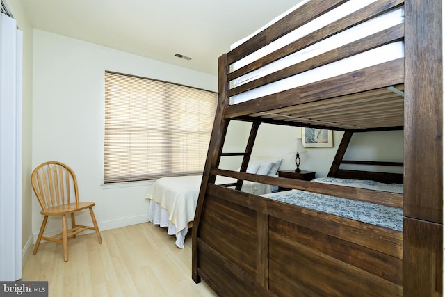 bedroom featuring baseboards and wood finished floors