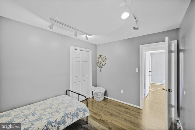 bedroom featuring wood finished floors and baseboards