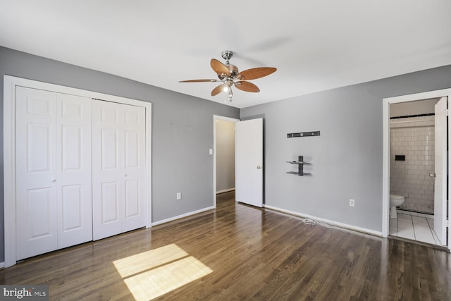 unfurnished bedroom with a closet, baseboards, and wood finished floors