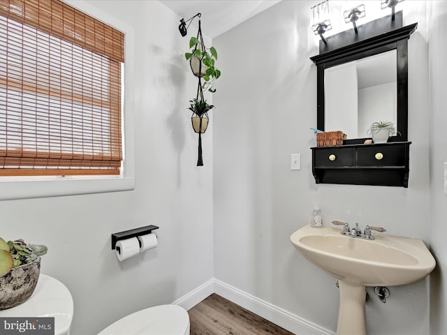 bathroom featuring baseboards, toilet, and wood finished floors