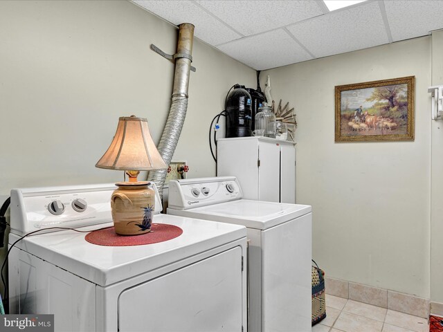 laundry area with laundry area, light tile patterned floors, and separate washer and dryer