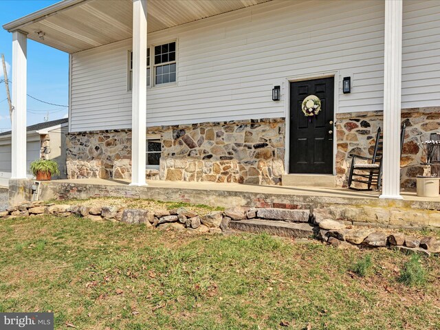 entrance to property featuring stone siding
