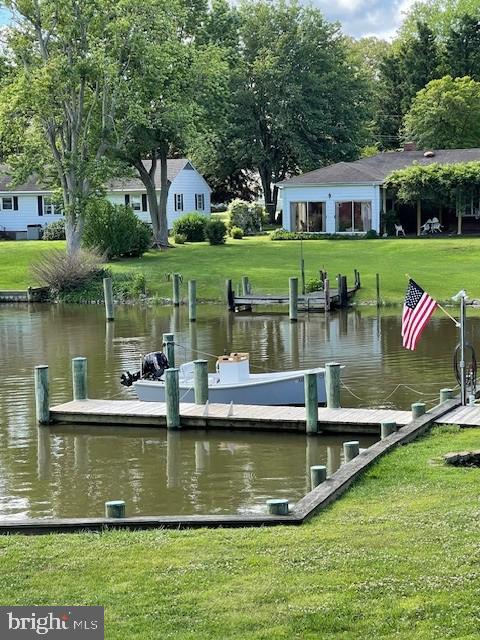 view of dock featuring a yard and a water view