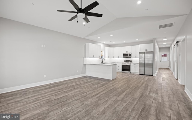 29345 Greenfield, Trappe, MD 21673 - kitchen featuring appliances with stainless steel finishes, a sink, ceiling fan, light countertops, and vaulted ceiling