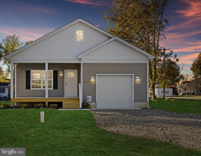 29345 Greenfield, Trappe, MD 21673 - view of front of house with a yard, a porch, an attached garage, driveway, and board and batten siding