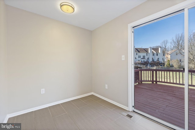 empty room with visible vents and baseboards