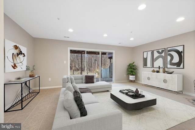 living room with tile patterned floors, recessed lighting, and baseboards