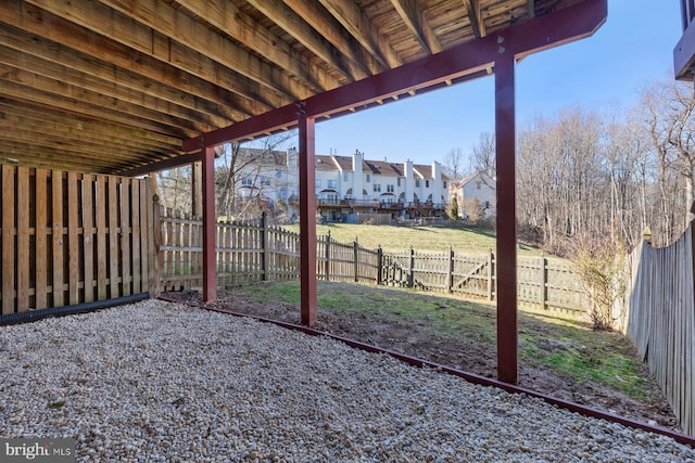 view of yard featuring a fenced backyard and a residential view