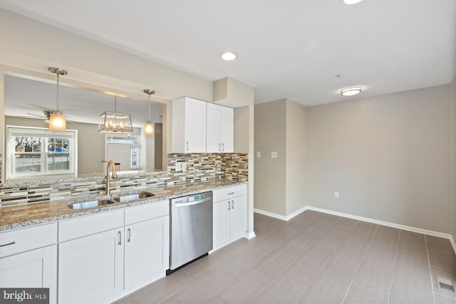 kitchen featuring light stone countertops, a sink, white cabinets, dishwasher, and backsplash