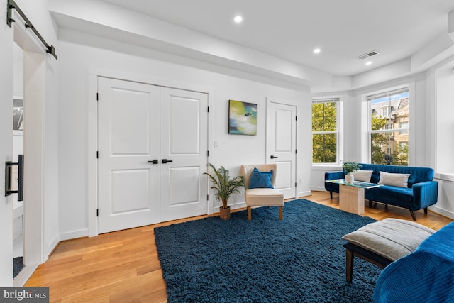1312 Fairmont St NW Unit 2, Washington, DC 20009 - living area featuring a barn door, light wood-style flooring, recessed lighting, and baseboards