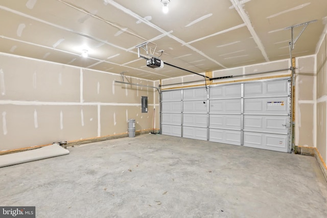 garage featuring electric panel and a garage door opener