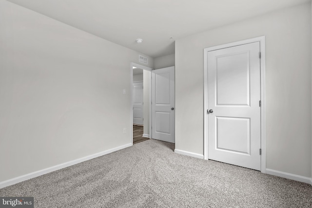 unfurnished bedroom with visible vents, baseboards, and carpet floors