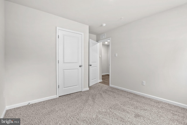 unfurnished bedroom featuring baseboards and carpet floors