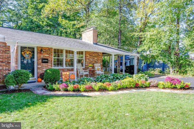 8605 Virginia Ave, Annandale, VA 22003 - back of property with a yard, a chimney, covered porch, and brick siding