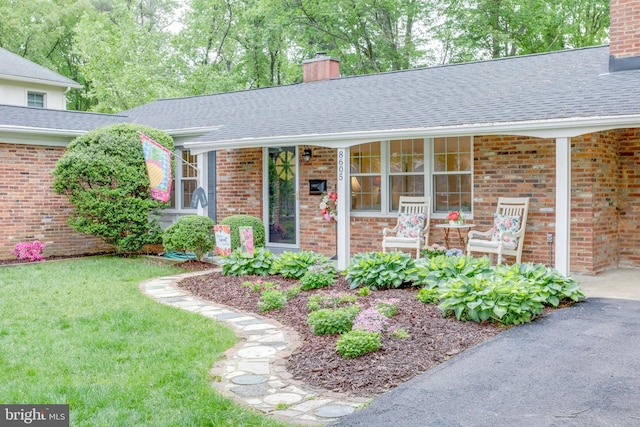 8605 Virginia Ave, Annandale, VA 22003 - property entrance with a chimney, brick siding, and roof with shingles