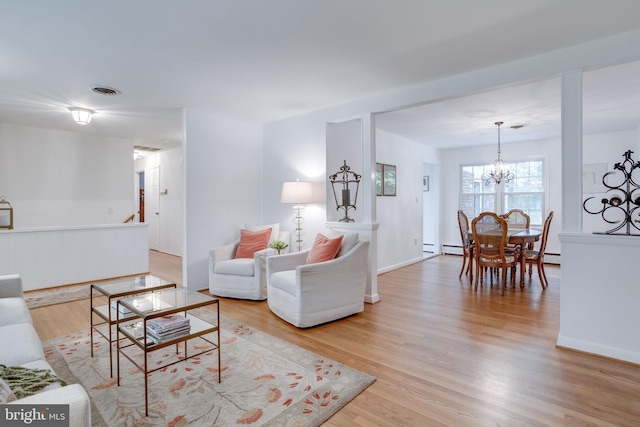 8605 Virginia Ave, Annandale, VA 22003 - living area with a chandelier, wood finished floors, and baseboards