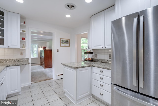 8605 Virginia Ave, Annandale, VA 22003 - kitchen featuring freestanding refrigerator, baseboard heating, healthy amount of natural light, white cabinets, and recessed lighting