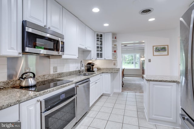8605 Virginia Ave, Annandale, VA 22003 - kitchen with appliances with stainless steel finishes, a sink, open shelves, white cabinets, and recessed lighting