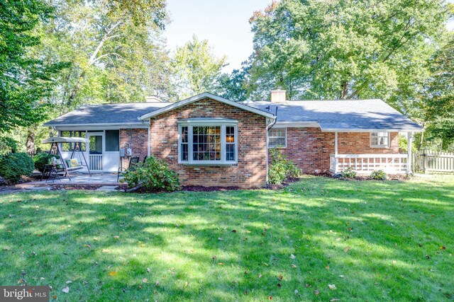 8605 Virginia Ave, Annandale, VA 22003 - rear view of property with a chimney, brick siding, and a patio area