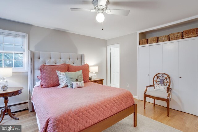8605 Virginia Ave, Annandale, VA 22003 - bedroom with light wood-type flooring, a baseboard heating unit, a closet, and ceiling fan