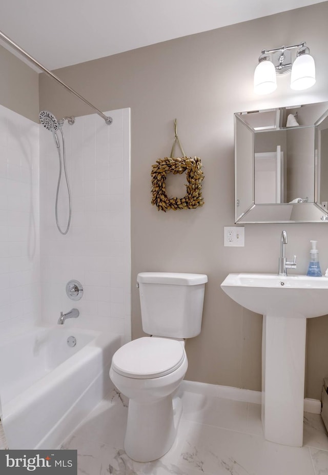 8605 Virginia Ave, Annandale, VA 22003 - bathroom with marble finish floors, toilet, baseboards, and shower / bath combination