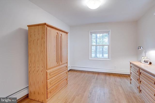 8605 Virginia Ave, Annandale, VA 22003 - unfurnished bedroom with a baseboard heating unit, light wood finished floors, and baseboards