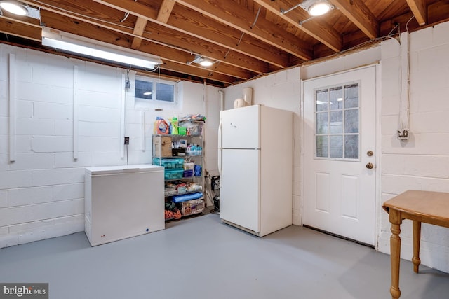 8605 Virginia Ave, Annandale, VA 22003 - unfinished below grade area featuring freestanding refrigerator, concrete block wall, and refrigerator