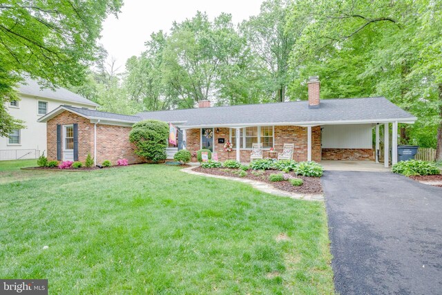 8605 Virginia Ave, Annandale, VA 22003 - view of front facade featuring a chimney, asphalt driveway, brick siding, and roof with shingles