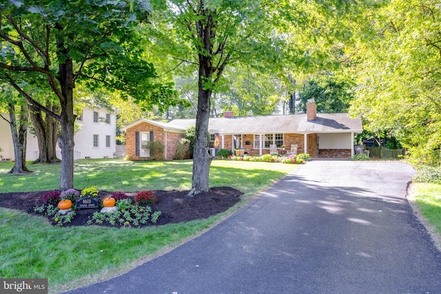 8605 Virginia Ave, Annandale, VA 22003 - view of front of property featuring driveway, a chimney, a front yard, and brick siding