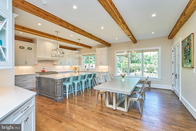 dining room featuring beamed ceiling, a notable chandelier, dark wood finished floors, recessed lighting, and baseboards