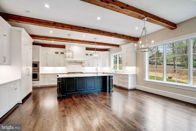 kitchen featuring a sink, an inviting chandelier, white cabinets, appliances with stainless steel finishes, and light countertops