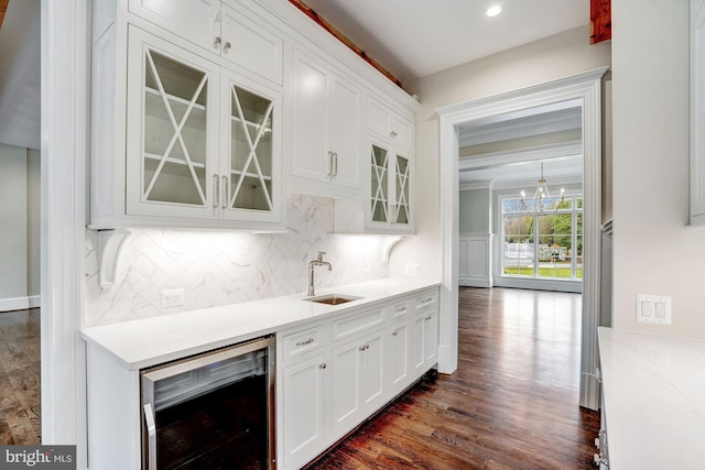 kitchen with white cabinetry, dark wood-type flooring, wine cooler, and a sink