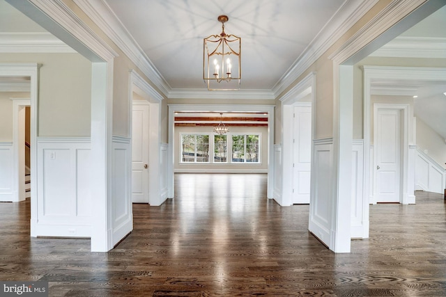 interior space with a chandelier, dark wood finished floors, and crown molding