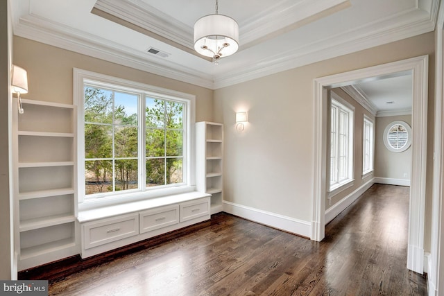 spare room featuring visible vents, a raised ceiling, and dark wood-style floors