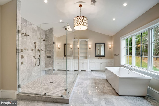 full bath with visible vents, a stall shower, a soaking tub, marble finish floor, and vanity