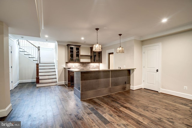 bar with dark wood-type flooring, tasteful backsplash, stairway, crown molding, and baseboards