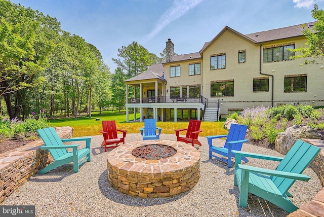 view of patio featuring a deck, stairway, and an outdoor fire pit