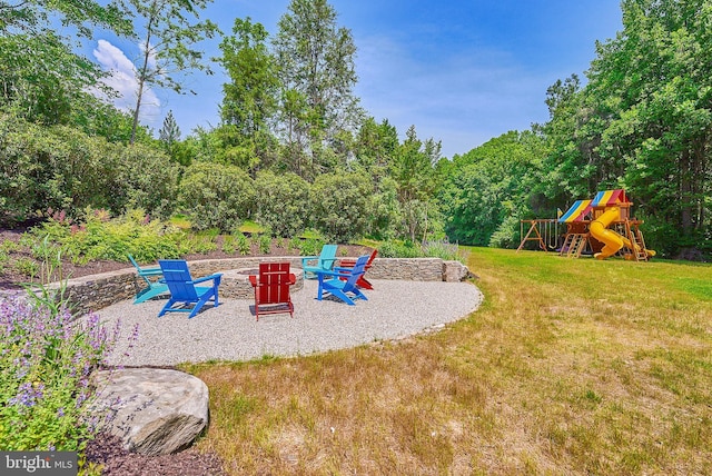 view of yard featuring a playground and a patio area