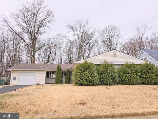 ranch-style house with driveway and a garage