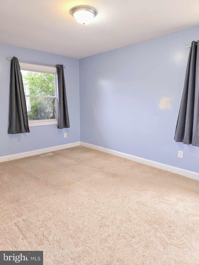 empty room with carpet flooring and baseboards