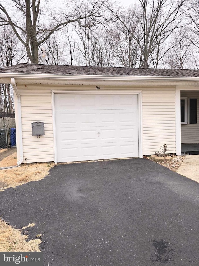 garage featuring aphalt driveway