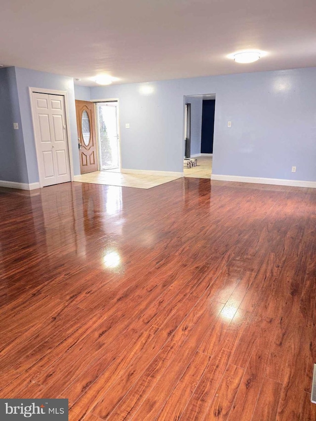 interior space with baseboards and wood finished floors