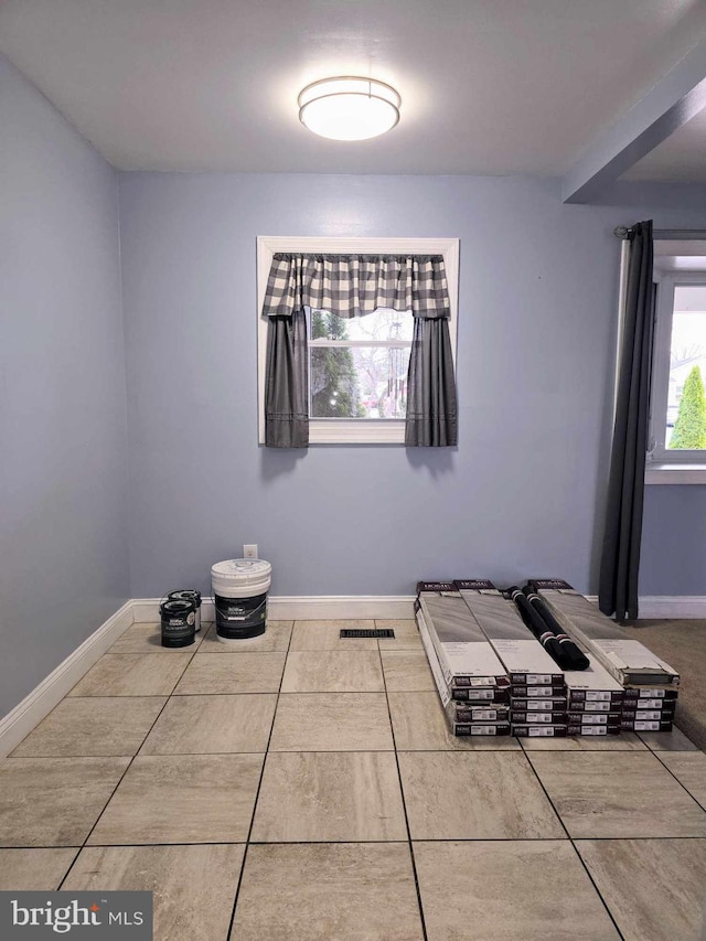 unfurnished bedroom featuring visible vents and baseboards