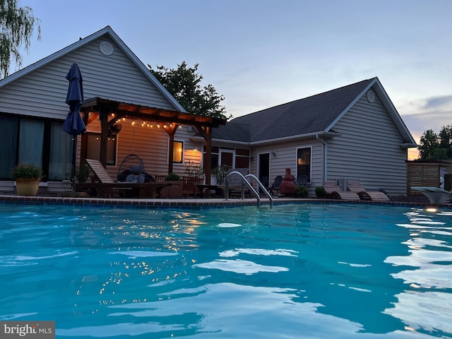 pool at dusk featuring an outdoor pool