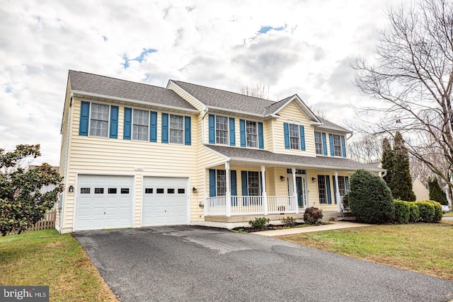 view of front of home with a front lawn, aphalt driveway, a porch, roof with shingles, and an attached garage