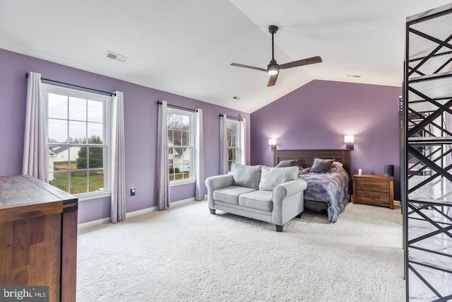 carpeted bedroom with lofted ceiling, baseboards, visible vents, and ceiling fan